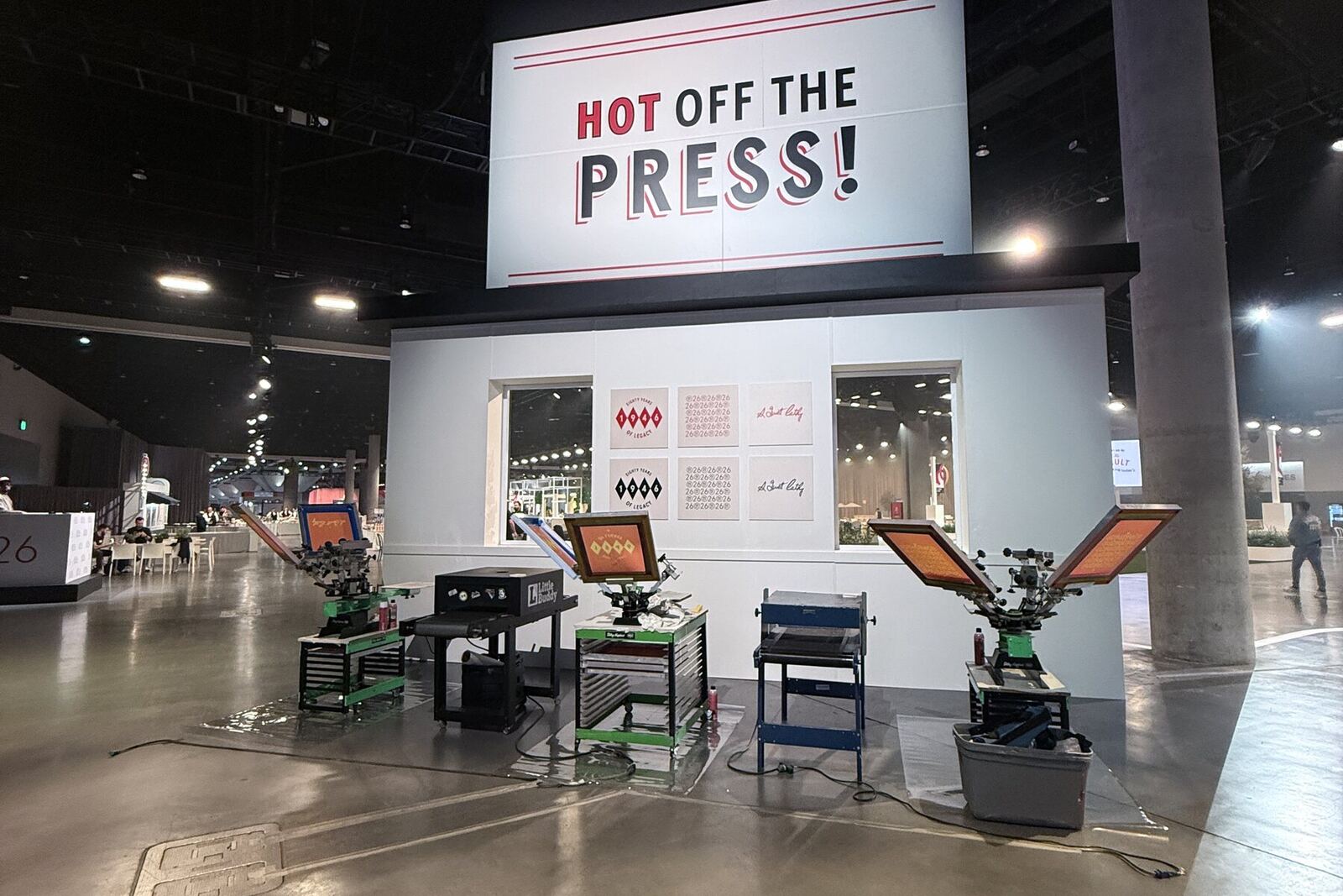 Convention center live printing booth with four press stations set before doors open