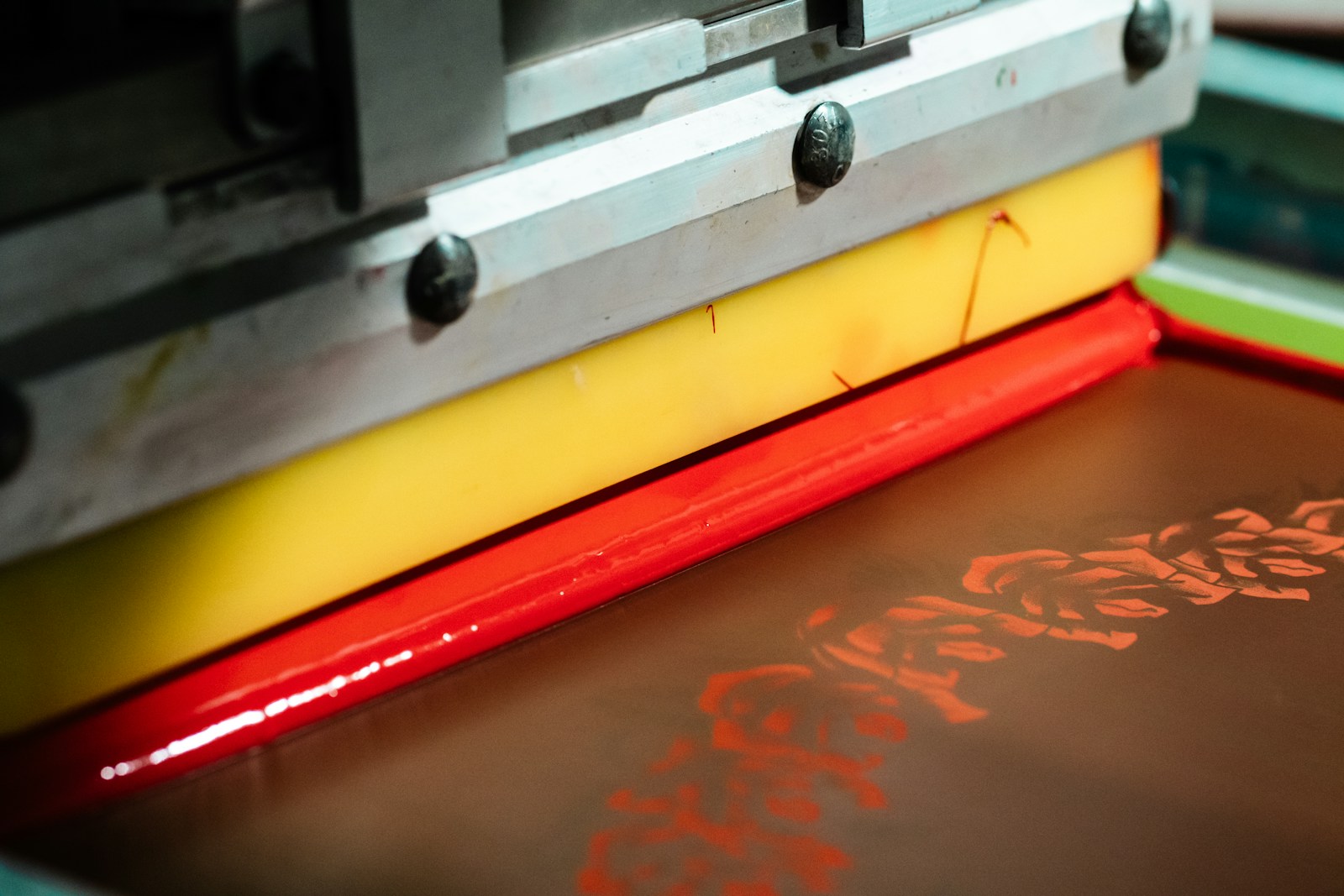 Close-up of print station machinery and ink during a live production run